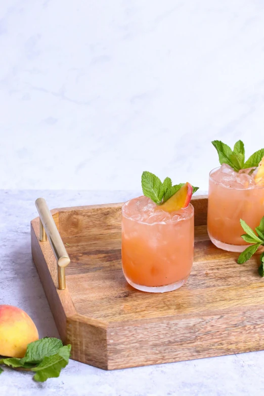 two small cocktail glasses with strawberries and limes