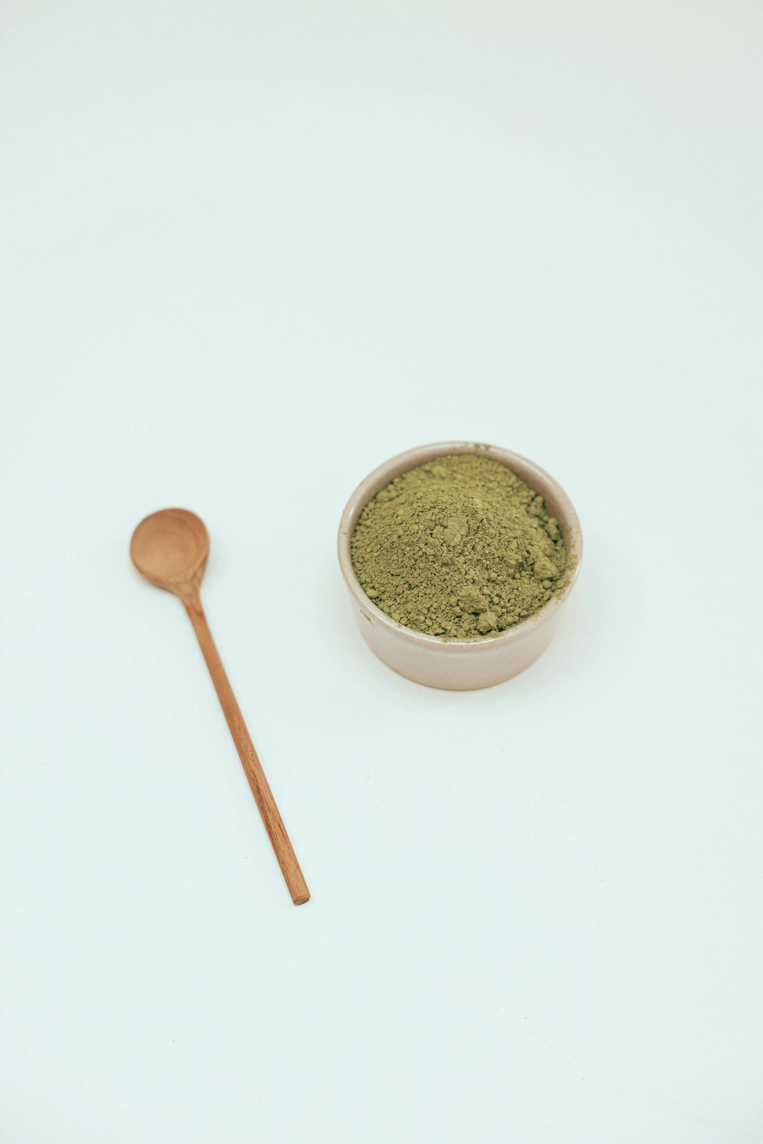 a bowl of matcha next to a wooden spoon, unsplash, detailed product image, sand color, full body image, made of glazed