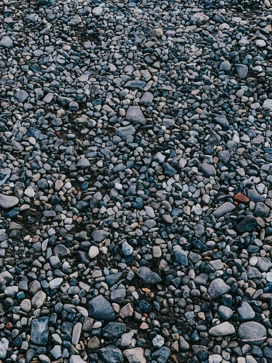 a red fire hydrant sitting on top of a pile of rocks, an album cover, by Hiroshi Honda, high resolution coal texture, pebbles, andres gursky, 5 feet away