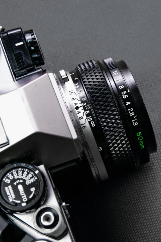 a close up of a camera on a table, looking down on the camera, 3 2 mm photograph, m.zuiko 75mm, high detail photograph