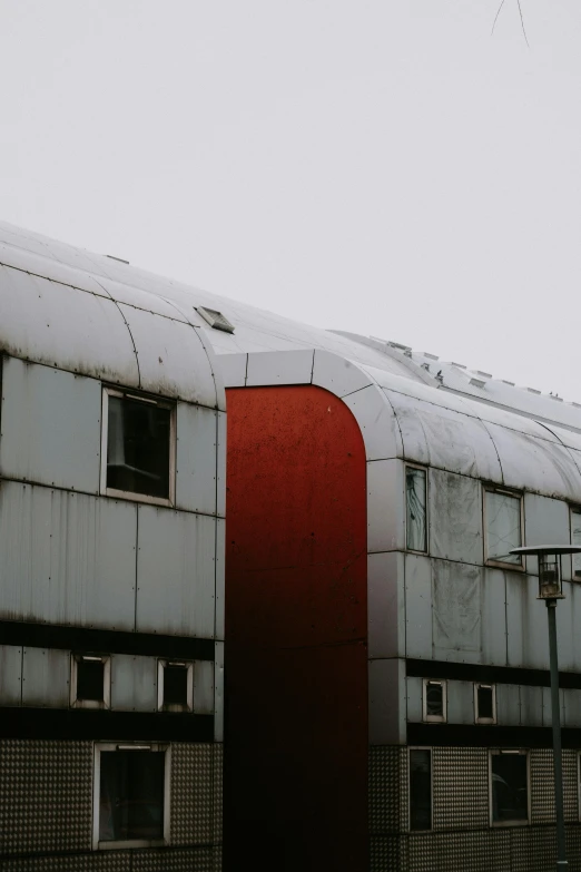 an old building with some windows on it and a red door