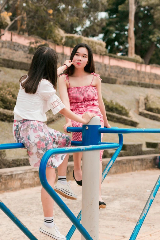 a couple of women standing next to each other on a playground, pexels contest winner, ulzzang, product introduction photo, talking, full colour