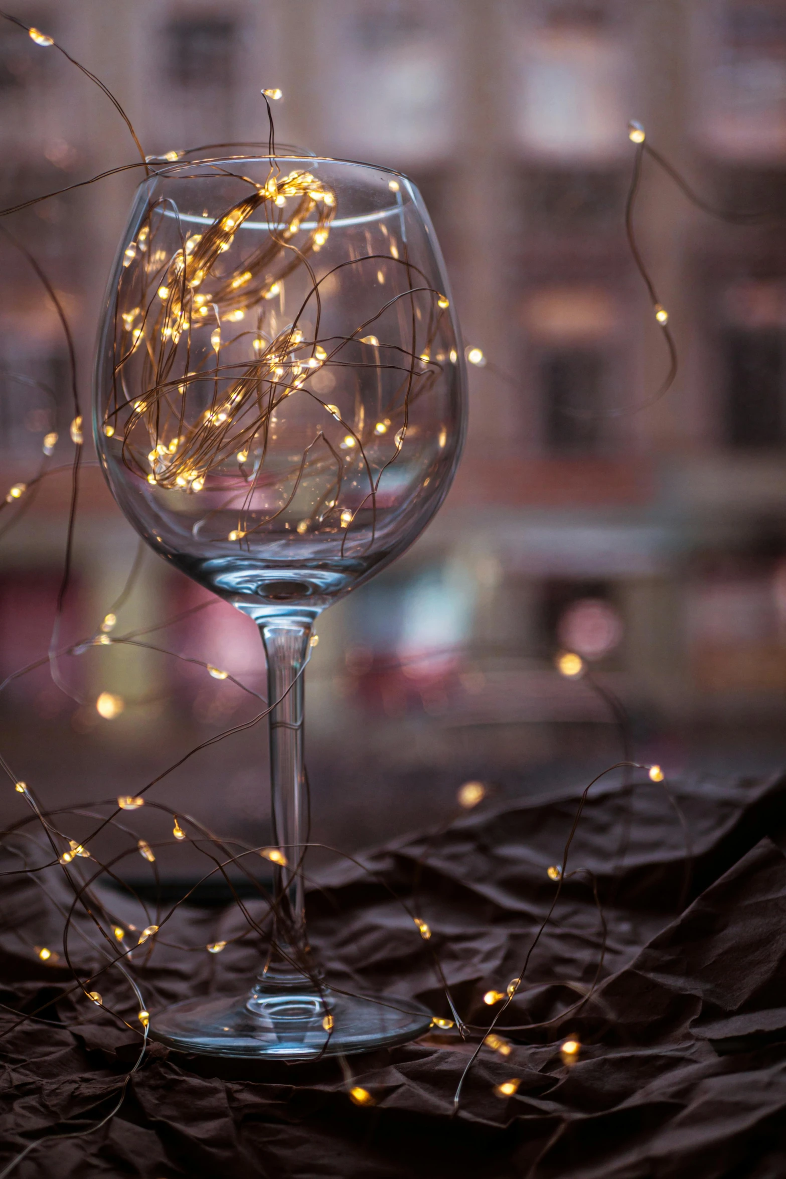 a wine glass with small white flowers sitting next to it