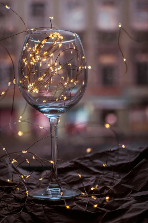 a wine glass with small white flowers sitting next to it