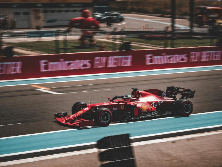 a red race car driving down a race track, pexels contest winner, f11, instagram post, hublot, france