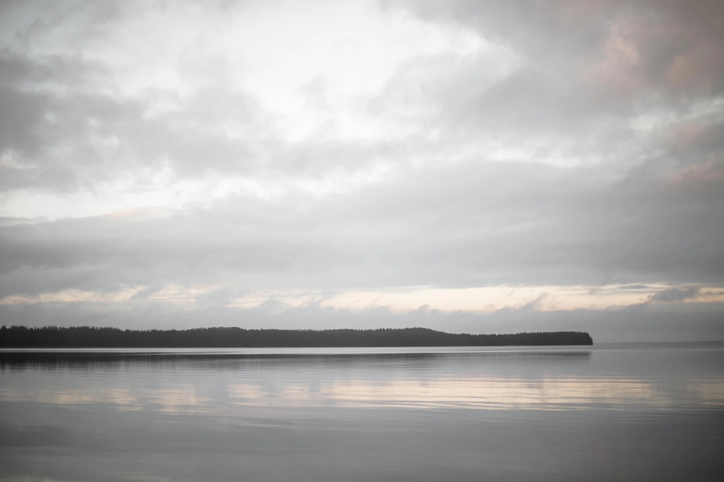 a lone plane flying over an island in the ocean