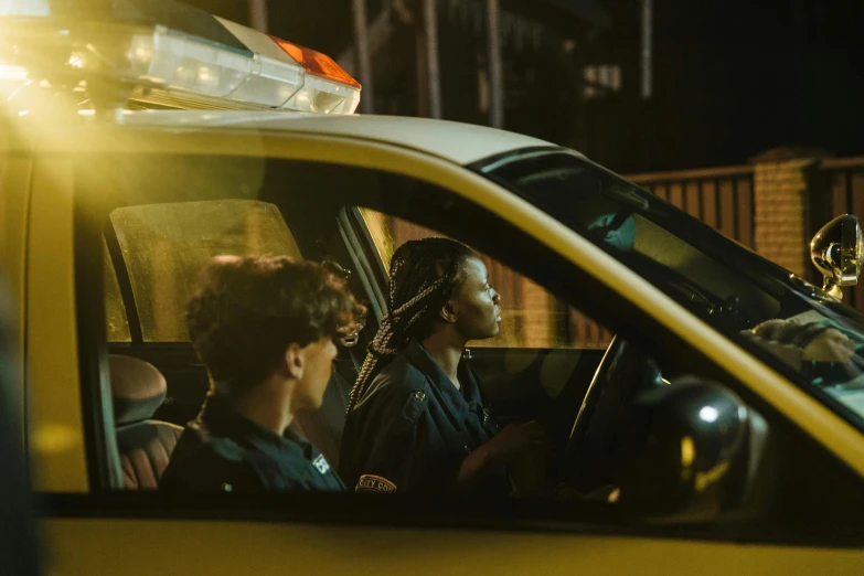 a car with the police on board is seen in a dark street