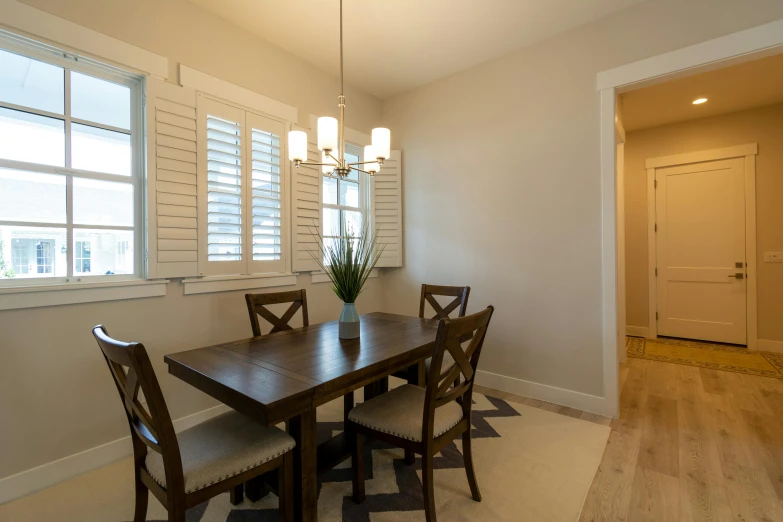 a dining table that has been placed next to the kitchen