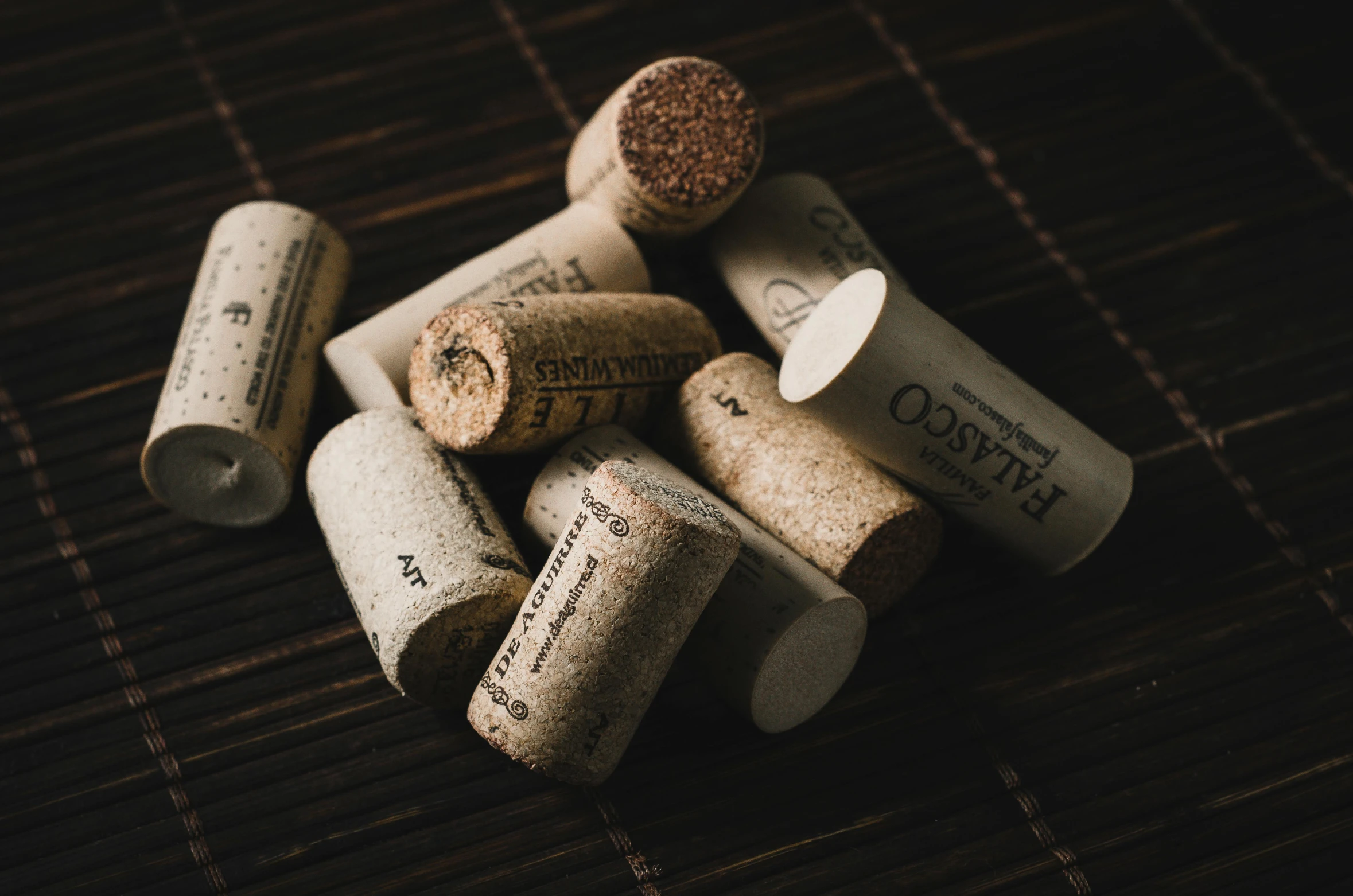 a pile of wine corks sitting on top of a table, unsplash photography, intricately detailed markings, high quality product image”