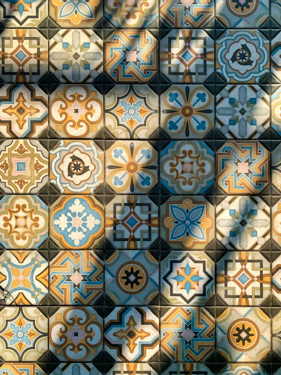 a black fire hydrant sitting on top of a tiled floor, a mosaic, inspired by Alberto Morrocco, trending on polycount, baroque, light grey blue and golden, high angle close up shot, colorful - patterns, taken on iphone 14 pro