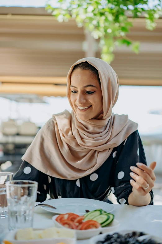 a woman sitting at a table eating food