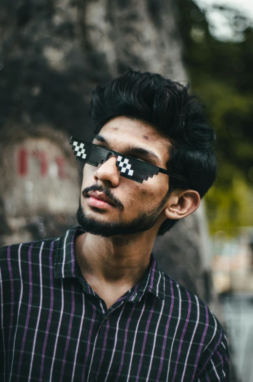 a young man with an ugly face and sunglasses