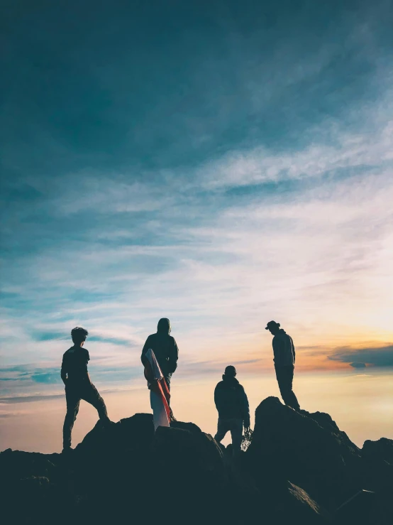 a group of people standing on top of a mountain, by Niko Henrichon, pexels contest winner, full body profile, backlit, oceanside, profile image