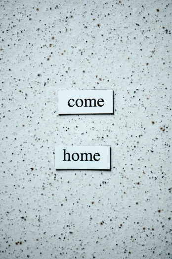 a piece of paper with the words come home written on it, diptych, magnetic, white concrete, background image