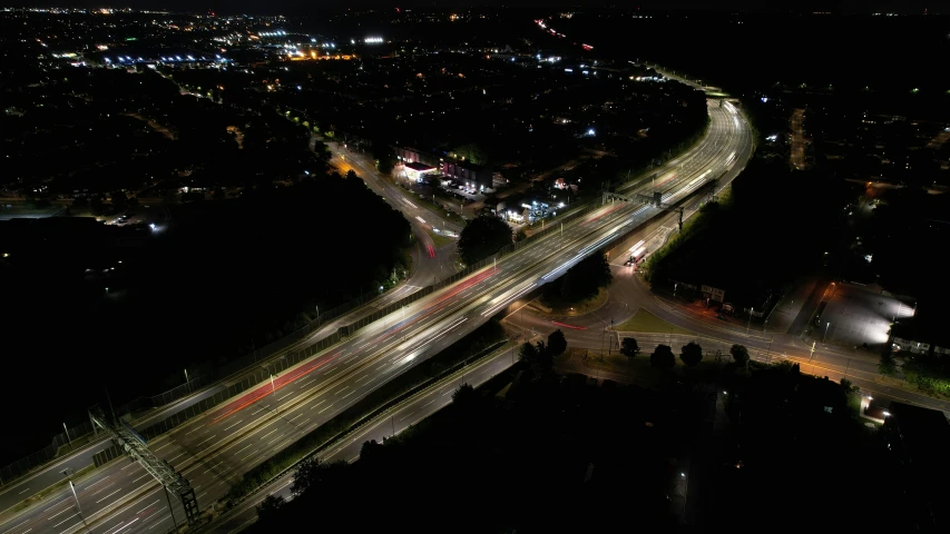 an aerial po taken at night showing a road intersection and interstate