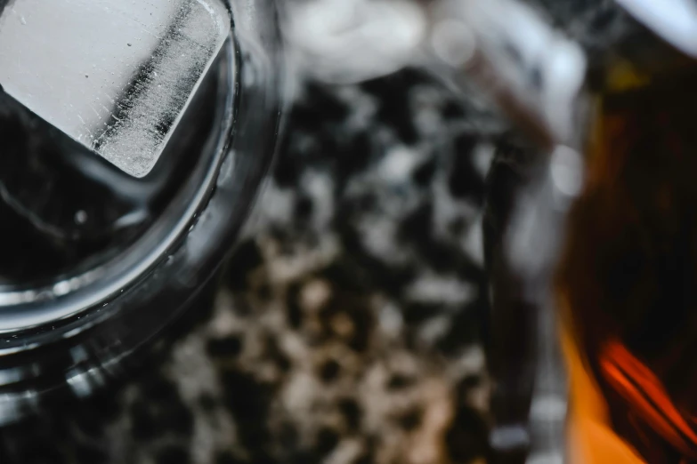 the bottom half of an iced beverage in a clear bottle