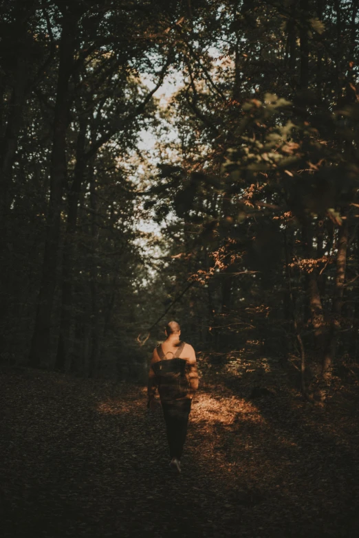 a person in the woods with some trees