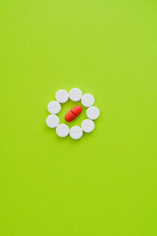 pills arranged in a circle on a green background, by Gavin Nolan, pexels, pop art, 4262862863, getty images, fluorescent, clemens ascher