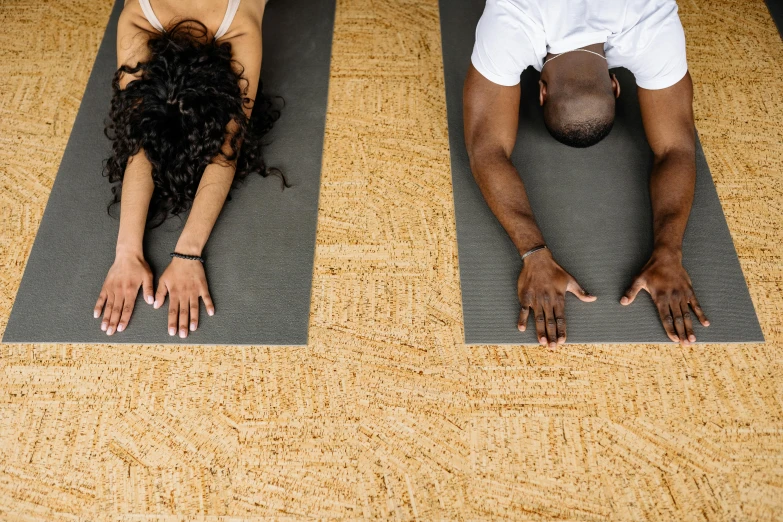 two people doing yoga poses together on their mats