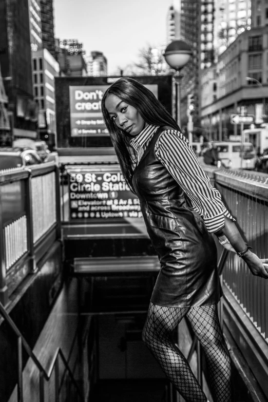 a black and white photo of a woman on an escalator, by derek zabrocki, happening, wearing leather, in times square, beautiful city black woman only, 5 0 0 px models