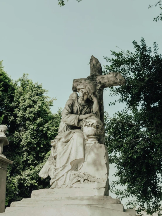 a statue of a woman sitting on top of a cross, a statue, inspired by Mihály Munkácsy, pexels contest winner, the graveyard, looking from shoulder, rich detail, split near the left