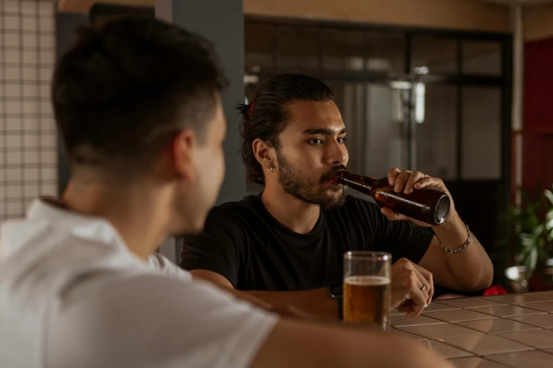 two men sitting at a bar drinking beer, pexels contest winner, profile image, straya, looking threatening, riyahd cassiem