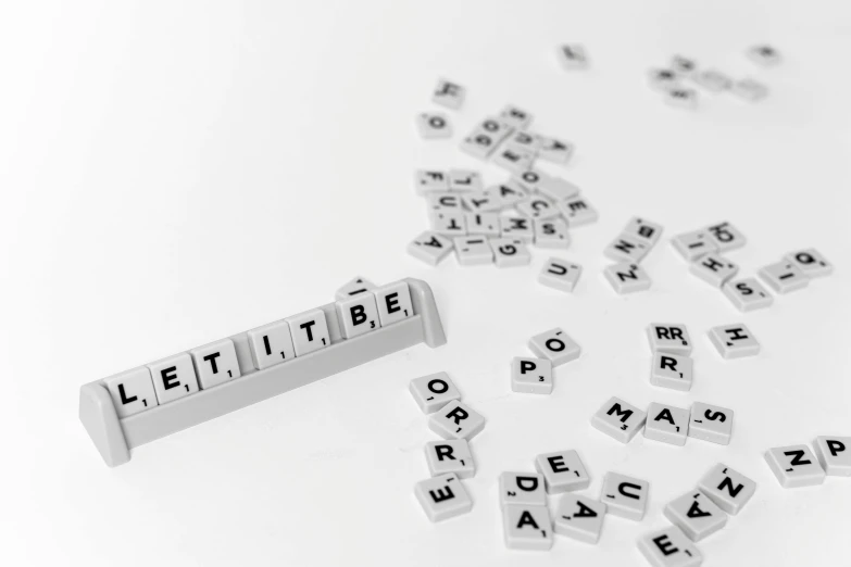 a bunch of letters sitting on top of a table, by Daniel Lieske, unsplash, letterism, tetris, white, dutiful return, on white