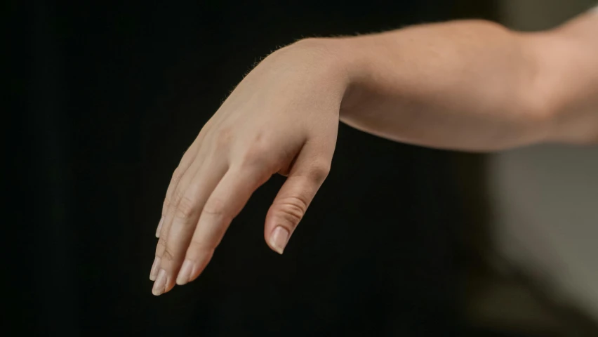 a woman's hand touching another persons arm