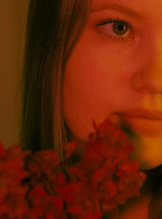 a  holding a bunch of flowers up to her face