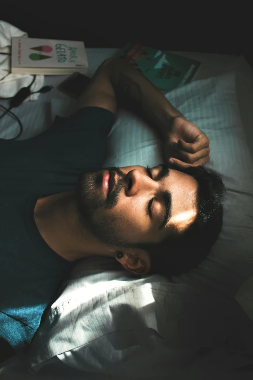 a man laying in bed with his eyes closed, pexels, renaissance, a portrait of rahul kohli, promo image, sleep paralysis, a high angle shot