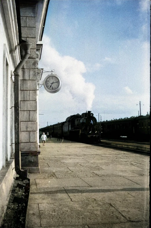 a train going down a train track in a station