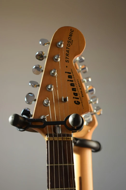 a close up of a guitar on a stand, in 2 0 1 5, gigachad portrait, stingray, standoff