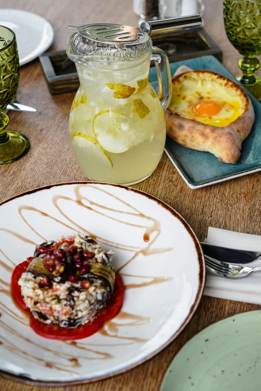 a close up of a plate of food on a table, by Julia Pishtar, middle eastern, chilean, drink, rustic