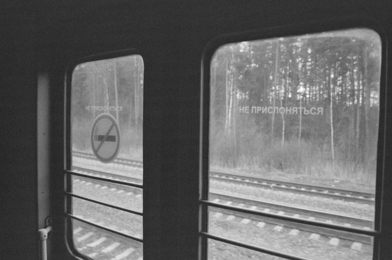 a black and white photo of a train window, an album cover, inspired by Yuri Ivanovich Pimenov, 000 — википедия, interior view, near forest, instagram picture