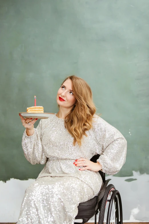 a woman in a wheelchair holding a cake, a portrait, by Julia Pishtar, trending on unsplash, full body full height, britt marling style 3/4, 15081959 21121991 01012000 4k, sadie sink