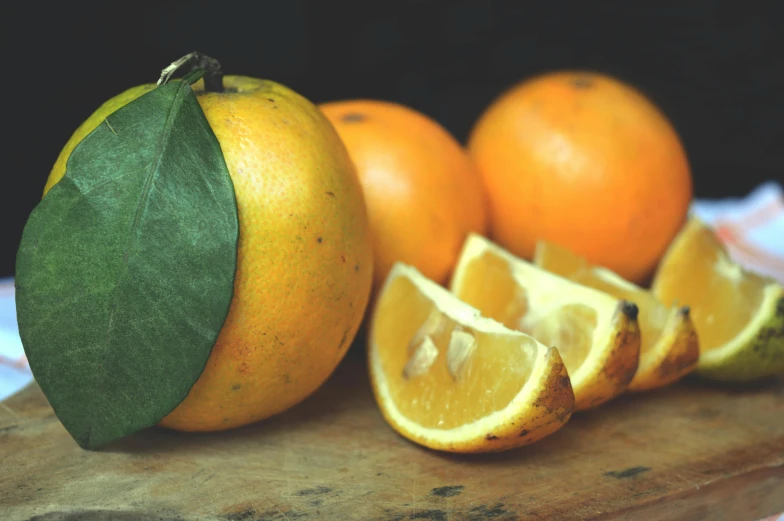 a bunch of oranges sitting on top of a cutting board, by Carey Morris, trending on pexels, yellow aureole, vintage photo, thumbnail, 🐿🍸🍋
