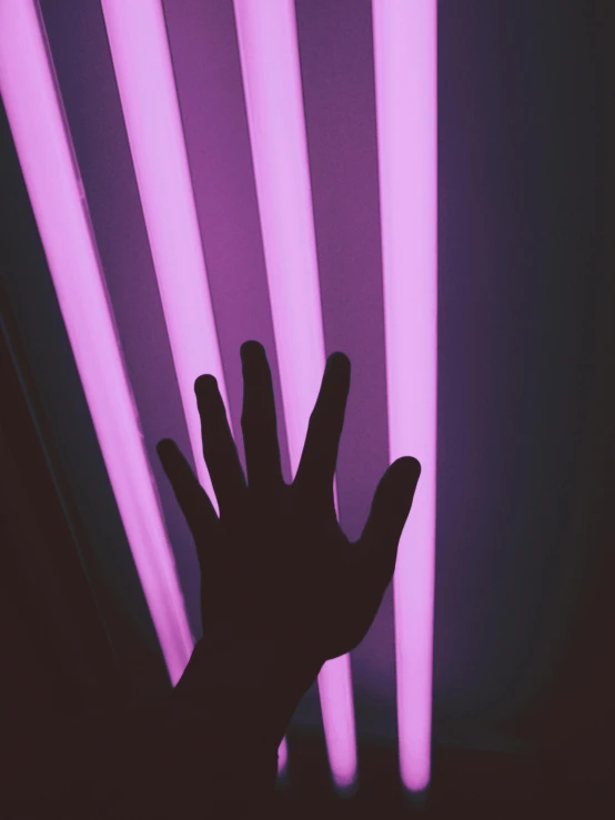 a person holding their hand up in front of a neon light, pexels contest winner, light and space, purple tubes, instagram story, sunlight filtering through skin, ((purple))