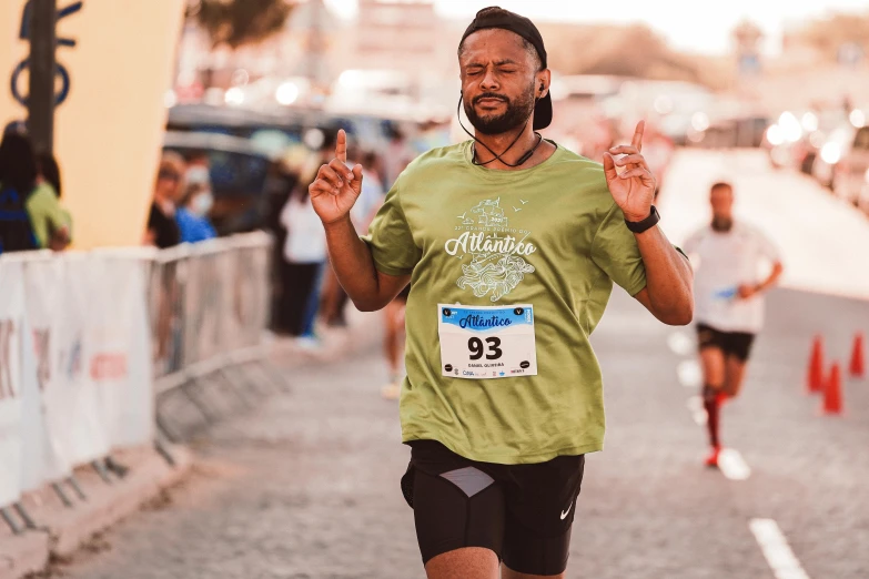 a man running in a marathon wearing a green shirt, by Matija Jama, pexels contest winner, renaissance, atlantis in the background, almost smiling, 🚿🗝📝