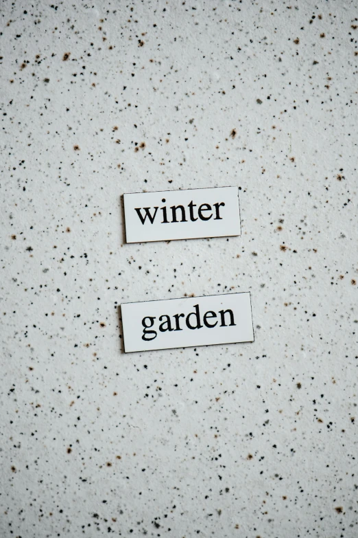 two pieces of paper that say winter and garden, white finish, medium close up, full, grey