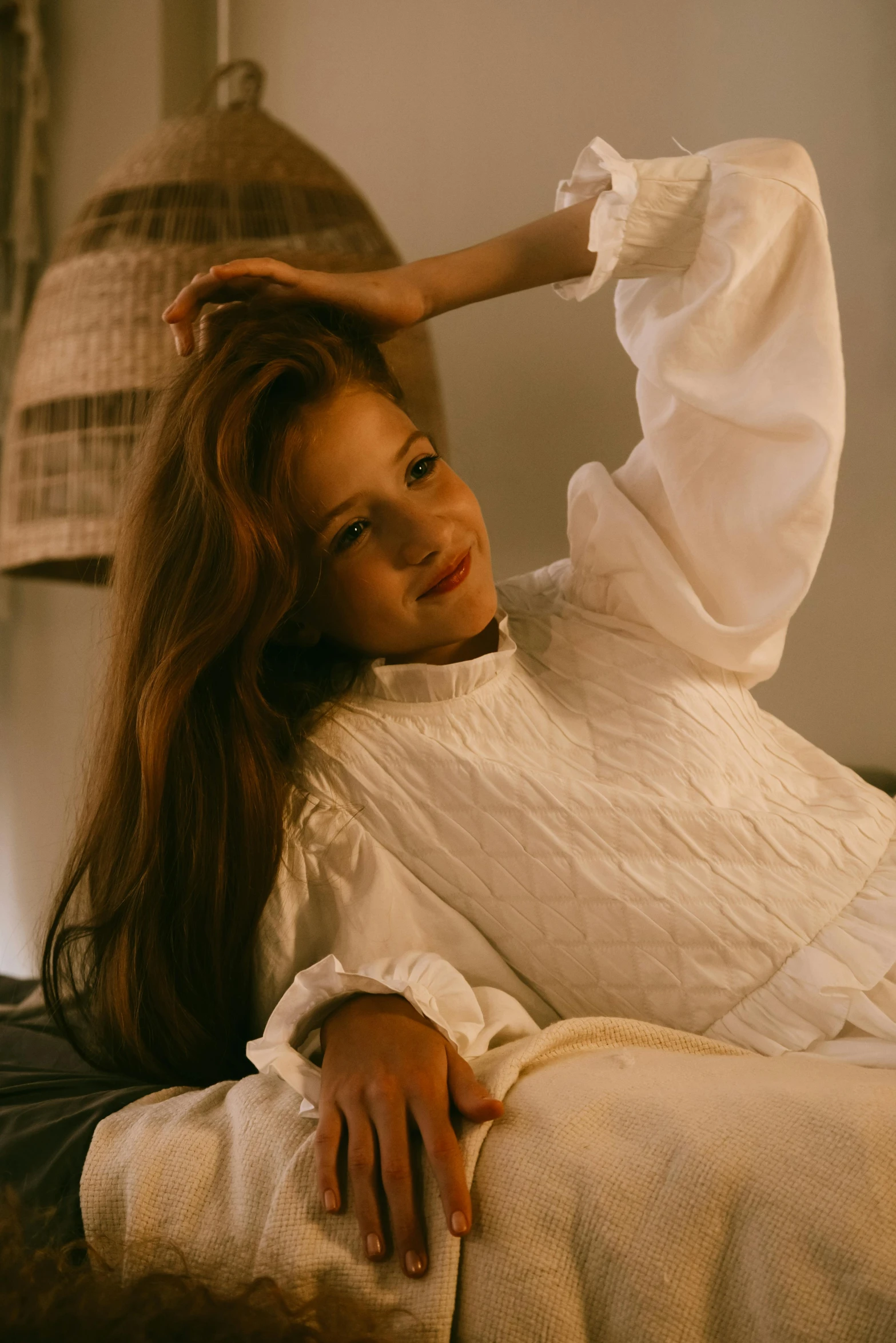 a woman laying on top of a bed next to a lamp, inspired by Elsa Bleda, trending on pexels, renaissance, white puffy outfit, looking happy, long glowing ethereal hair, long sleeves