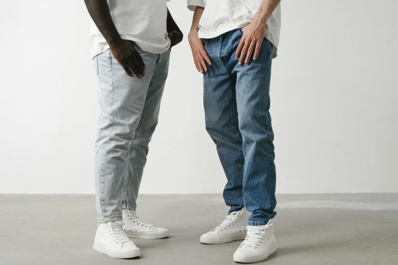 two men stand with their legs around each other