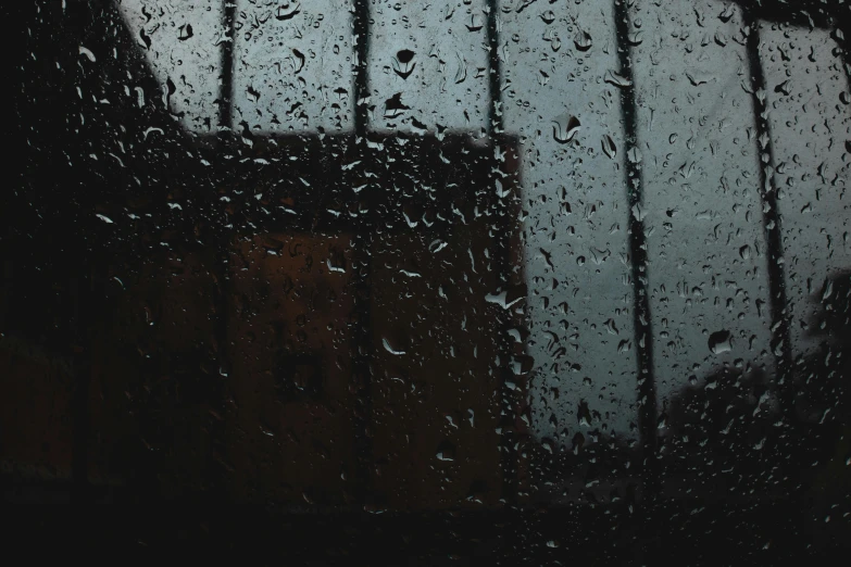 a view of a building through a rain covered window, inspired by Elsa Bleda, pexels contest winner, visual art, ☁🌪🌙👩🏾, weeping tears of black oil, wet reflections in square eyes, depressed mood