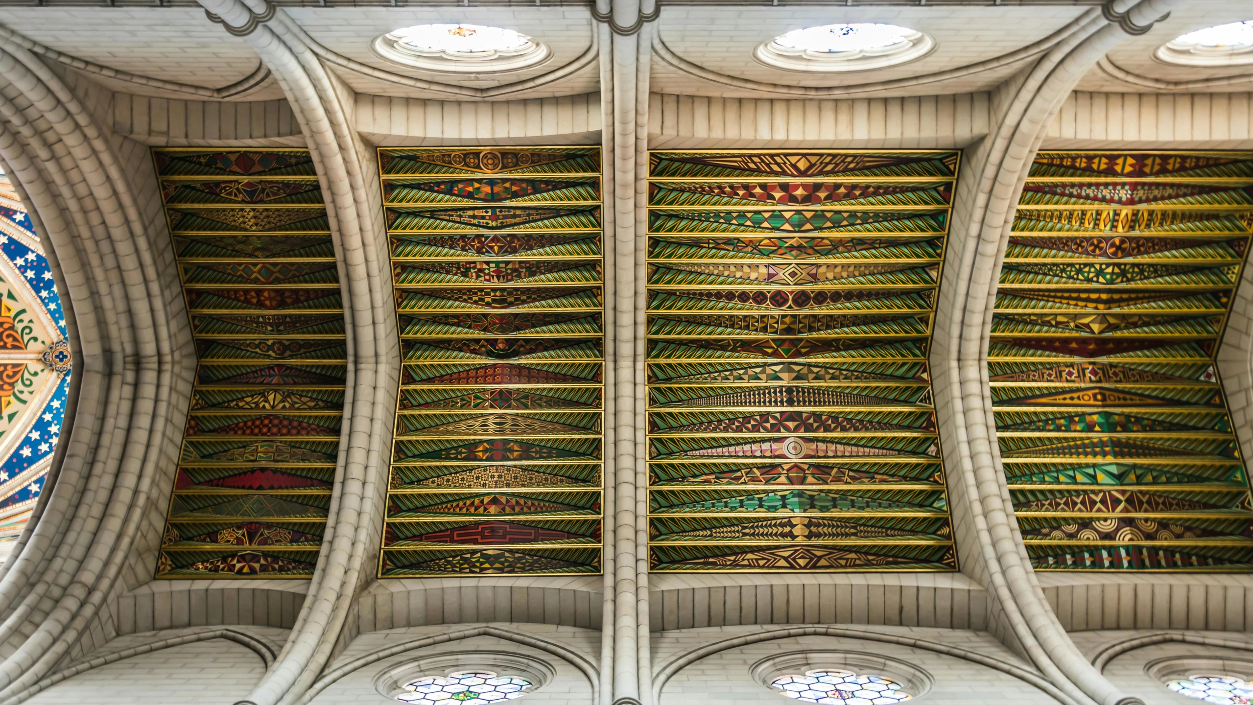 the inside of a cathedral with many colored stained glass windows