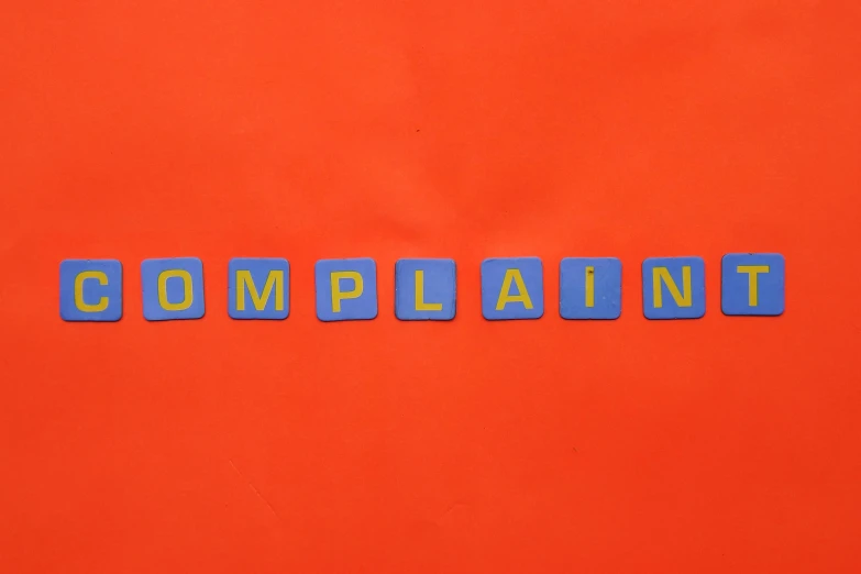 the word complaints spelled out in colored wood type letters