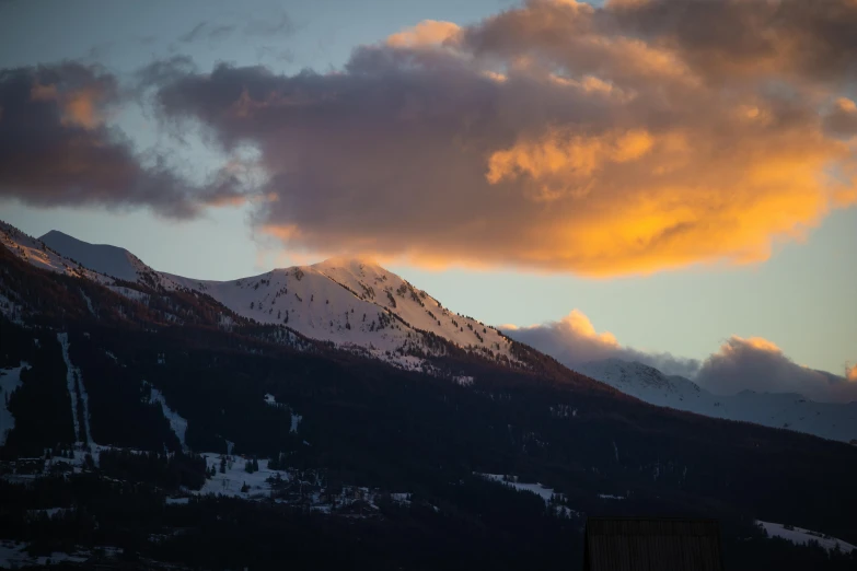 a very large mountain with some clouds in the background