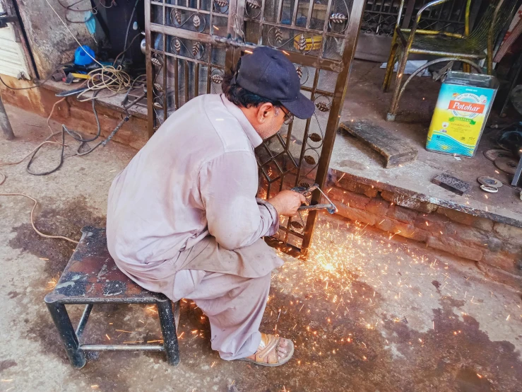 a man on a bench working with a welding device