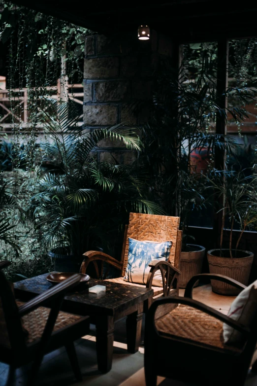 chairs, an ottoman, and coffee table all sit out on a patio