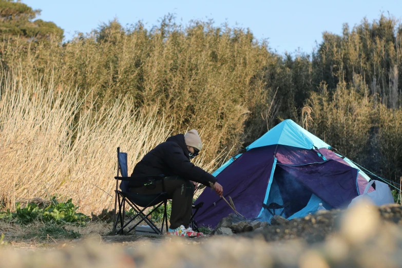 a person sitting in a chair next to a tent, fishing, 千 葉 雄 大, profile image, campsites