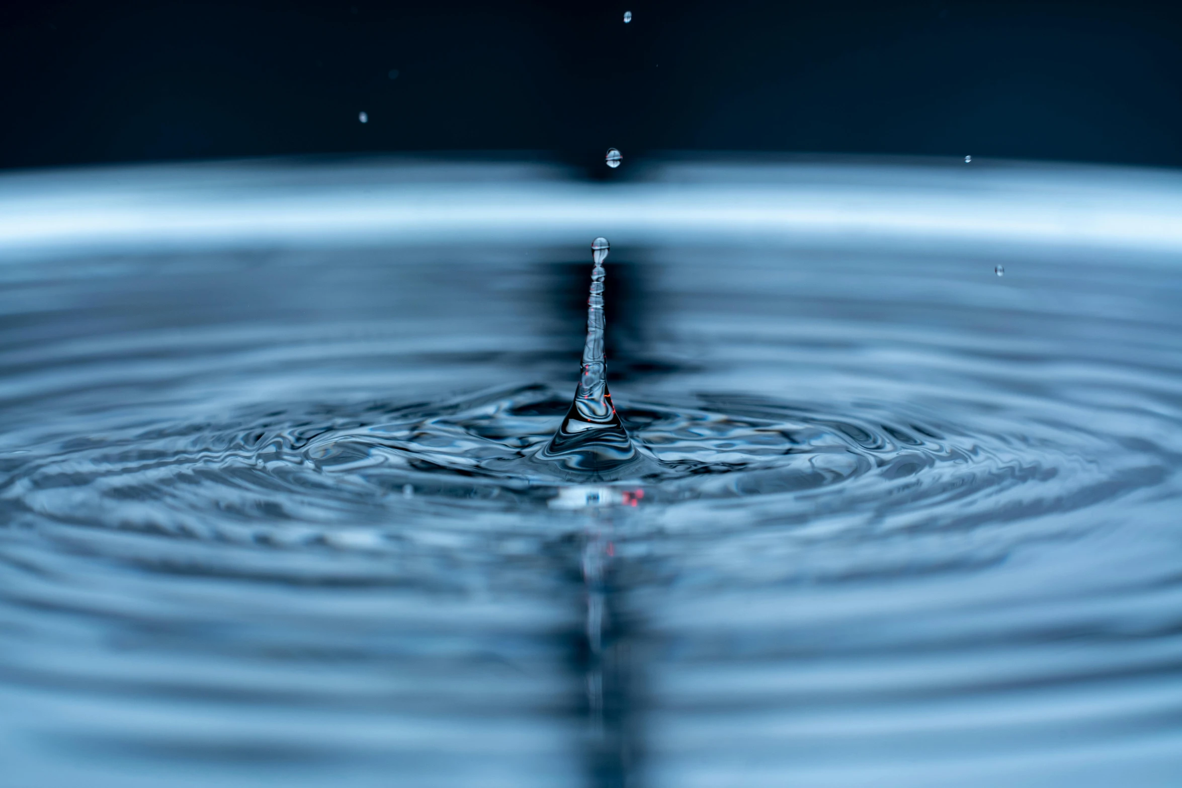 a drop of water falling into a pool of water, unsplash, renaissance, rippling electromagnetic, fan favorite, hyperreal highly detailed 8 k, round-cropped