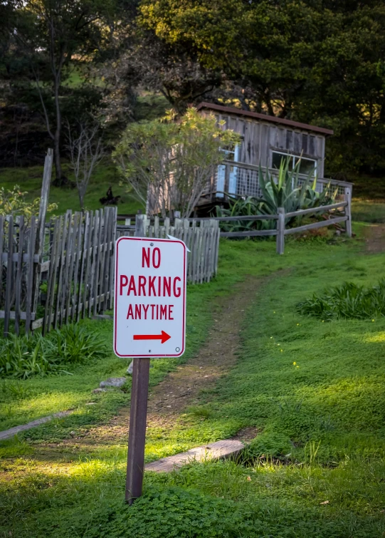 a no parking sign at an old style house
